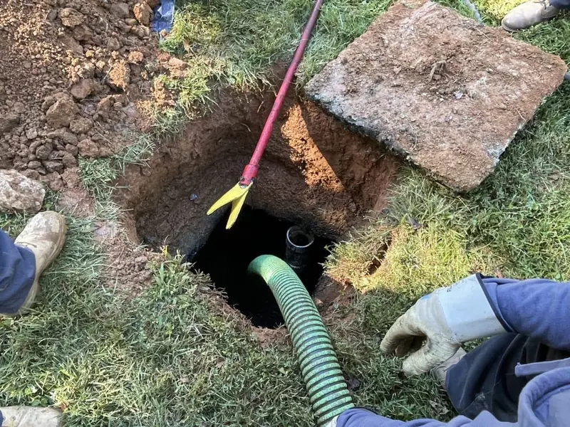Septic tank being cleaned out through the access opening