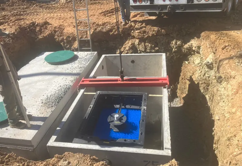 New septic tank being set during a system installation