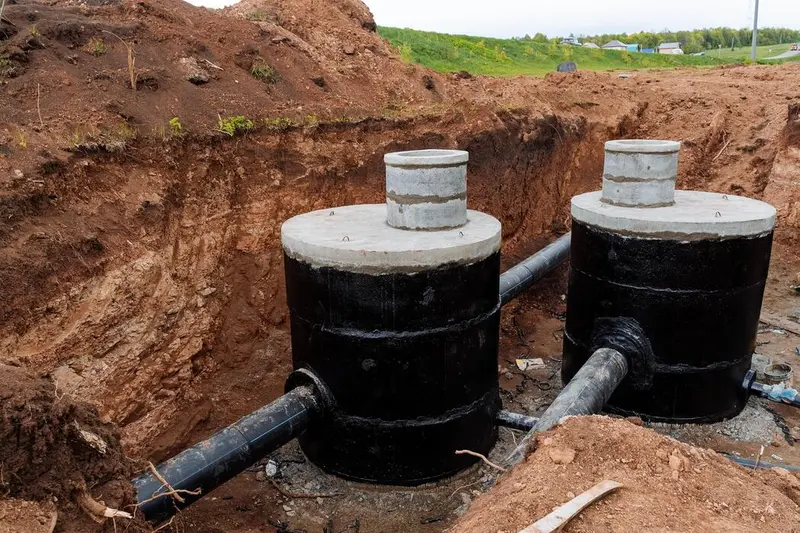 Two new septic tanks set in an excavation with connecting pipe